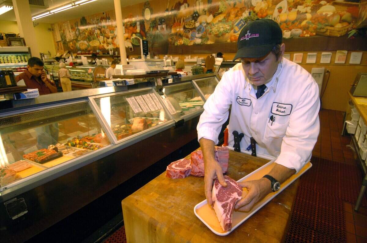 In 2007, Rudiger Fersch, a butcher at Epicure Market on Alton Road, cuts beef for his customers.